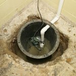 Sump pit with pump and PVC piping for water management at Great Day Plumbing & Air services.