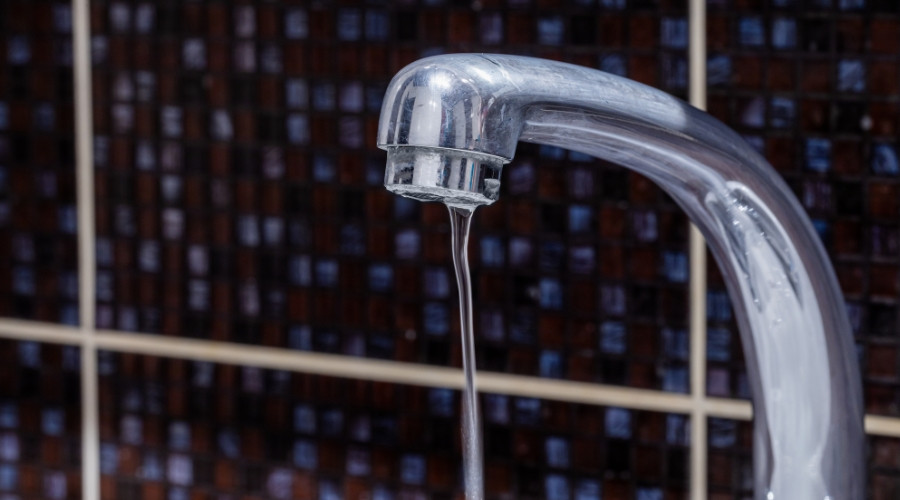 Chrome faucet with low water flow illustrating water pressure issues.